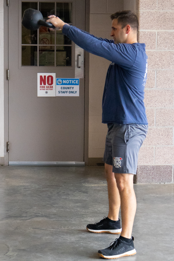 Lieutenant Tyler Brenneman does kettlebell swings at Sedgwick County Fire District 1 Station 32 on April 19.