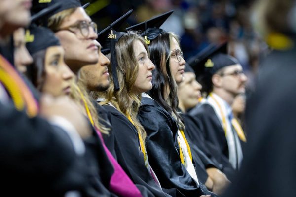 Graduates listen as Iris Okere, former SGA President, addresses 2024 graduates and their families. (File photo)