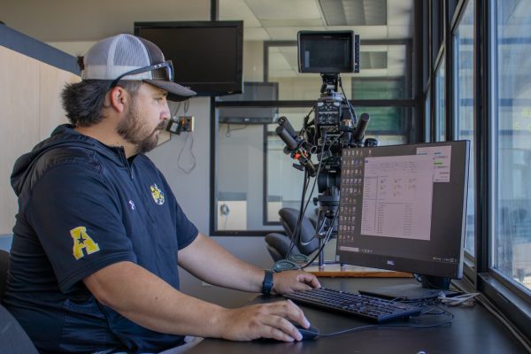 Emilio Escamilla, the director of video and data analytics for Wichita State baseball, runs the TrackMan system on the third floor of Eck Stadium on May 8.