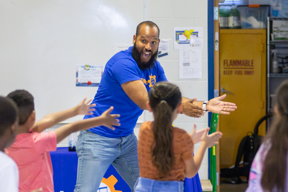 Roy Moye III leads students of Linwood Elementary through a dance as he sings one of his STEM-oriented songs. The kids jumped, spun, danced, clapped and sang along with Moye as he performed his show.