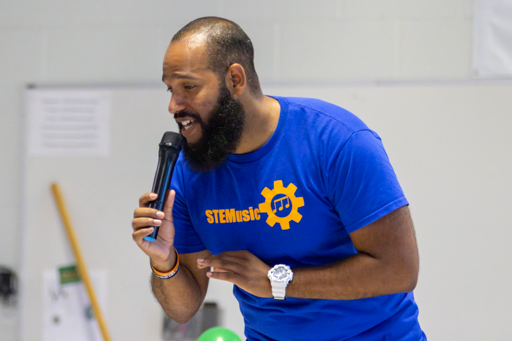 Roy Moye III sings a song about engineering while performing a STEM-based show for students of Linwood Elementary. Moye led students through songs, activities and experiments to inspire them to pursue STEM-oriented careers.