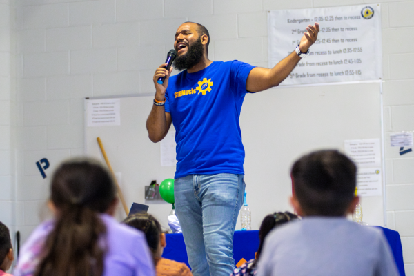 Roy Moye III sings a song about engineering while performing a STEM-based show for students of Linwood Elementary. Moye led students through songs, activities and experiments to inspire them to pursue STEM-oriented careers.