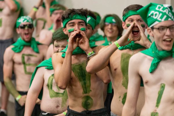 Engineering students chant together as they prepare to head outside for the Clash of the Colleges event on Aug. 23. The Pre-Party for engineering students allowed some to get letters and exclamation marks painted on their chests.