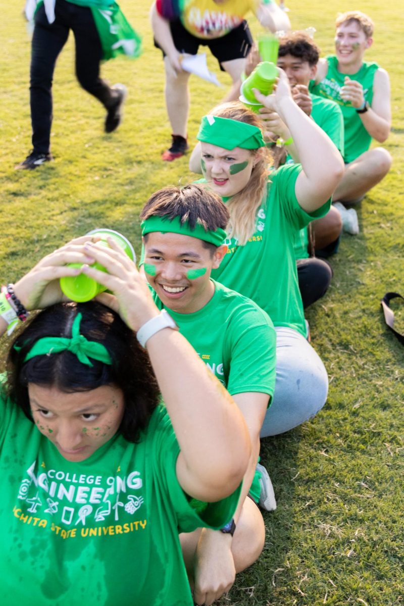 College of Engineering students participate in a pass the water relay race during Clash of the Colleges on Aug. 23.