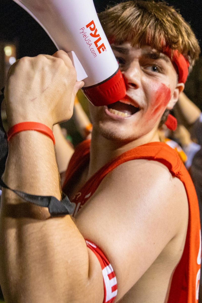 Barton School of Business student Ambrose Blubaugh speaks into a megaphone during the 10th annual Clash of the Colleges on Aug. 23.