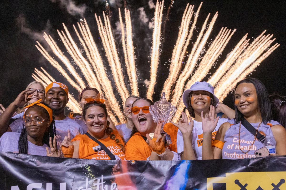 The winners of clash of the colleges, the College of Health Professions, pose while their photo is taken beneath fireworks on Aug. 23 at the 10th annual Clash of the Colleges competition.