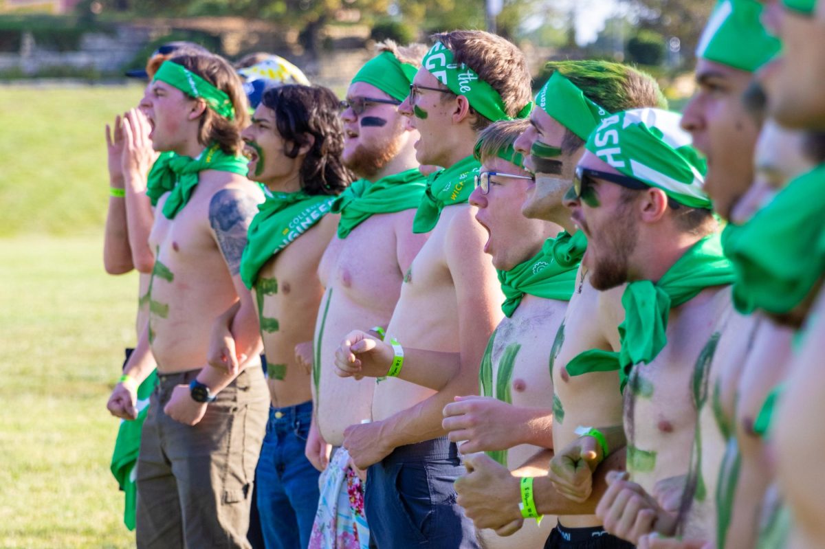 The College of Engineering Clash of the Colleges team with painted stomachs scream their slogan before the competition began Aug. 23. The engineering slogan went: "Who's everybody fearing?" and their response was, "Engineering."