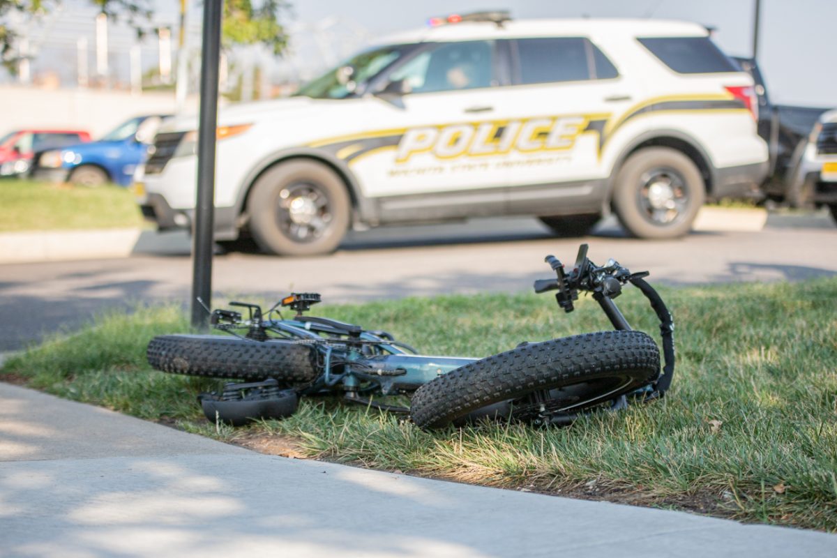 A bike rests on the grass after a collision with a car on 17th Street on Aug. 27. The cyclist was taken to the hospital.