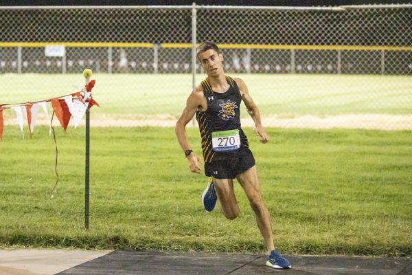 Redshirt freshman Colin Graham rounds a bend at his first uniformed cross country meet on Friday night. Graham came in 18th at 21:09.42, within the pack of WSU men's runners.