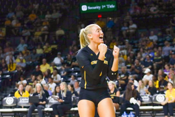 Junior libero Katie Galligan pumps her fists in celebration during WSU's exhibition game against Kansas State on Aug. 24.