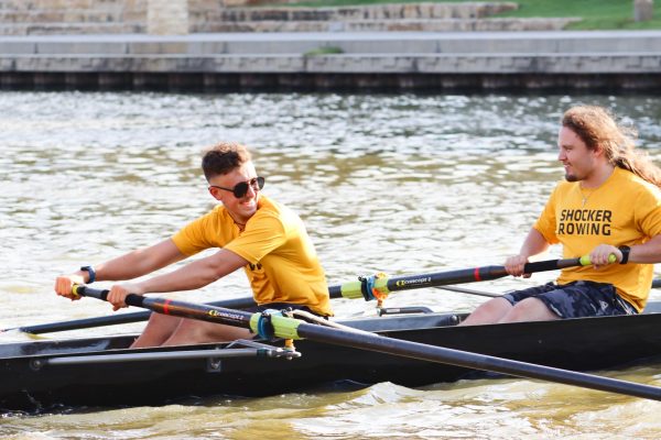 WSU shocker rowing team members Marc Bergman and Caden Yurko giggle while rowing. Both are on members of the Shocker Rowing competitive team.