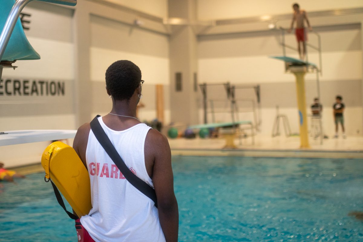 Junior Kayden Rawls watches over the diving pool during the Launch Week pool party on Aug. 15 in Wiedemann Pool. The event kicked off the 2024 Launch Week and Shockfest celebrations.