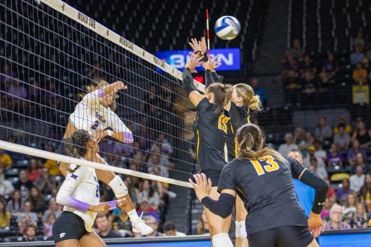 Senior middle blocker Morgan Stout and fifth-year setter Izzi Strand attempt to block a Kansas State spike on Aug. 24. The Wildcats swept the exhibition game in three sets.