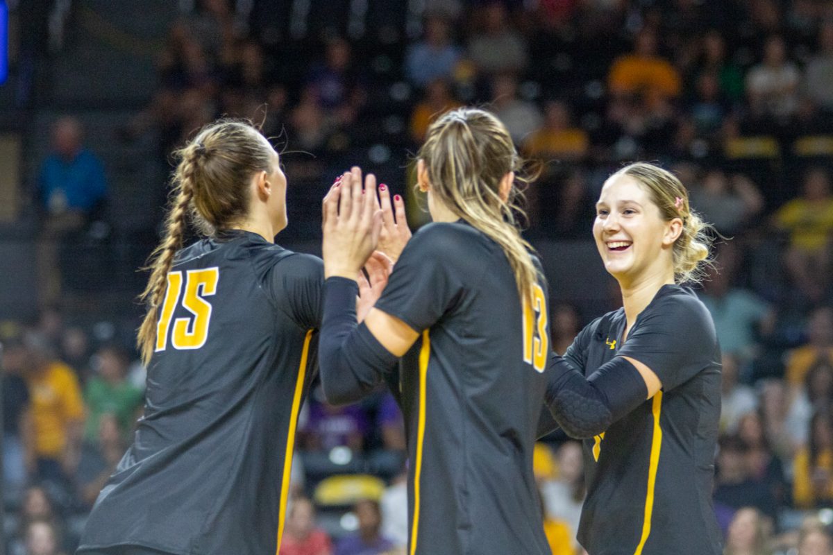 Senior Morgan Stout, junior Emerson Wilford and fifth-year Izzi Strand celebrate after a point during WSU's exhibition game against Kansas State on Aug. 24. Stout and Strand were named unanimously to the AAC's 2024 preseason all-conference team.