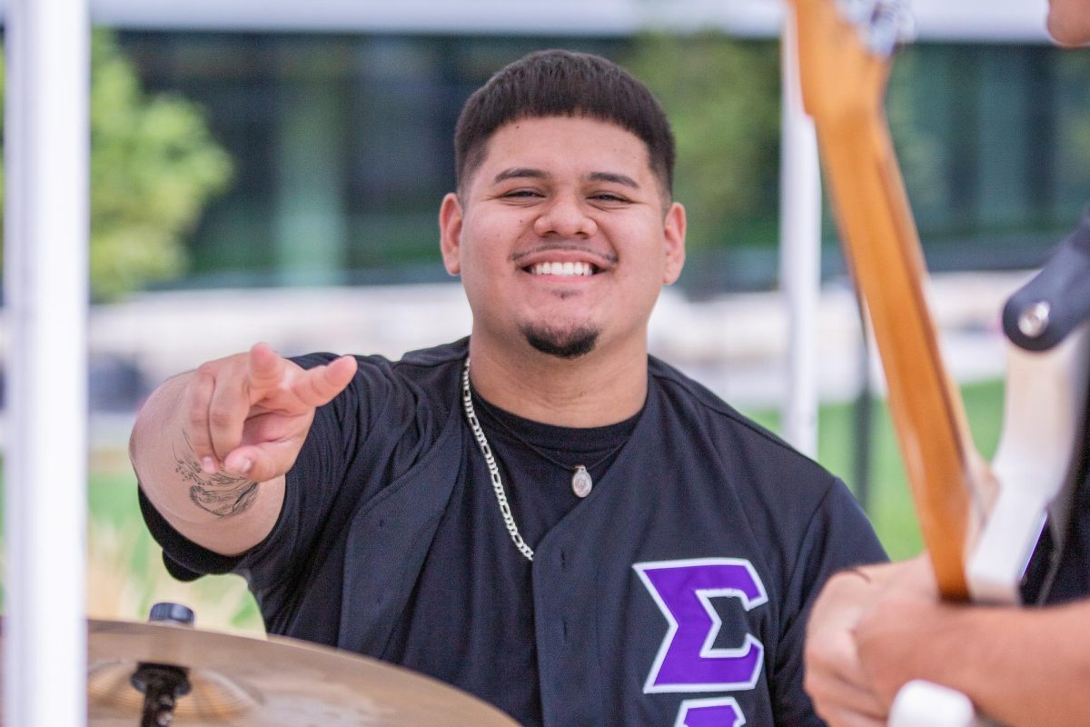 Carlos Sosa smiles at the "Picnic at the Patio" on Aug. 20. Sosa played the drums at the event hosted by the Student Government Association on the east side of the Rhatigan Student Center.