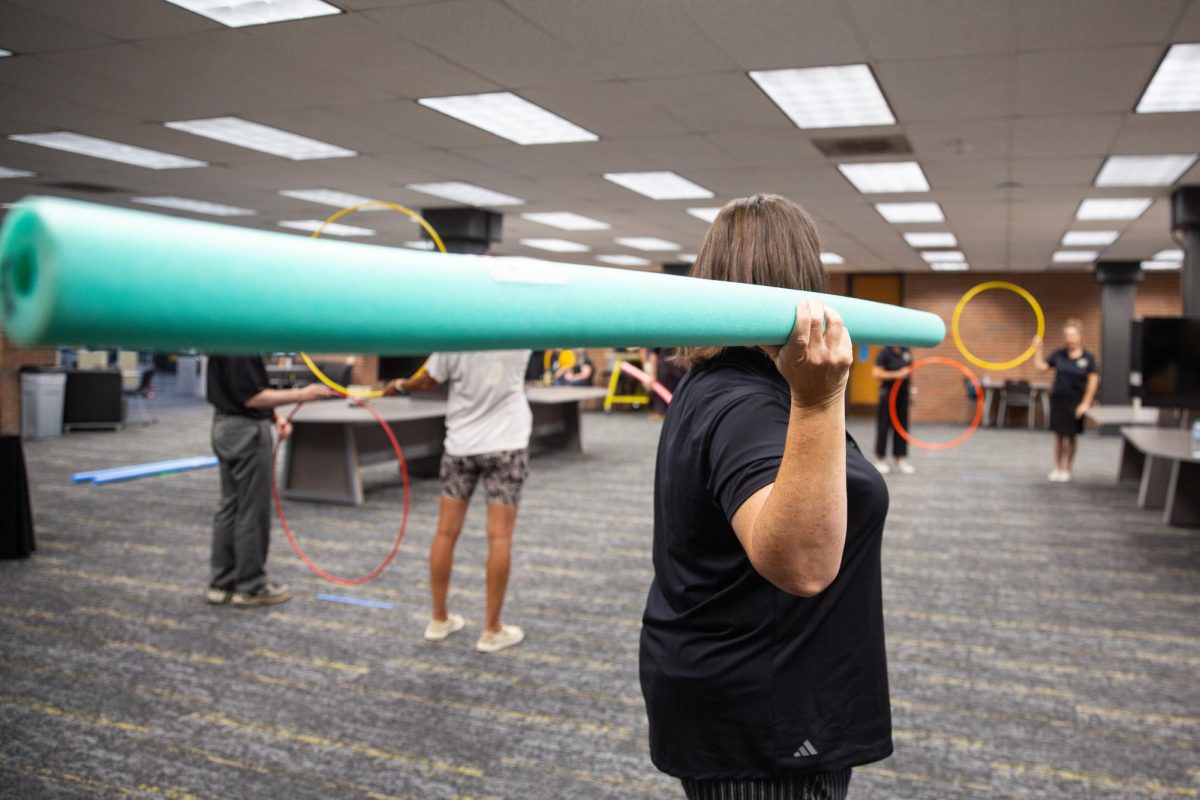 Faculty and staff practice their javelin throwing skills with pool noodles and hula hoops. The inaugural Faculty/Staff Olympics featured other activities such as rowing, golf, bowling and more.