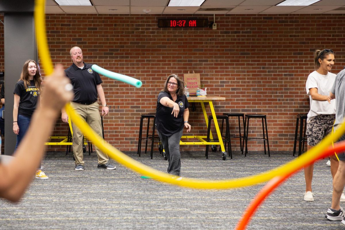 Faculty and staff practice their javelin throwing skills with pool noodles and hula hoops. The inaugural Faculty/Staff Olympics featured other activities such as rowing, golf, bowling and more.