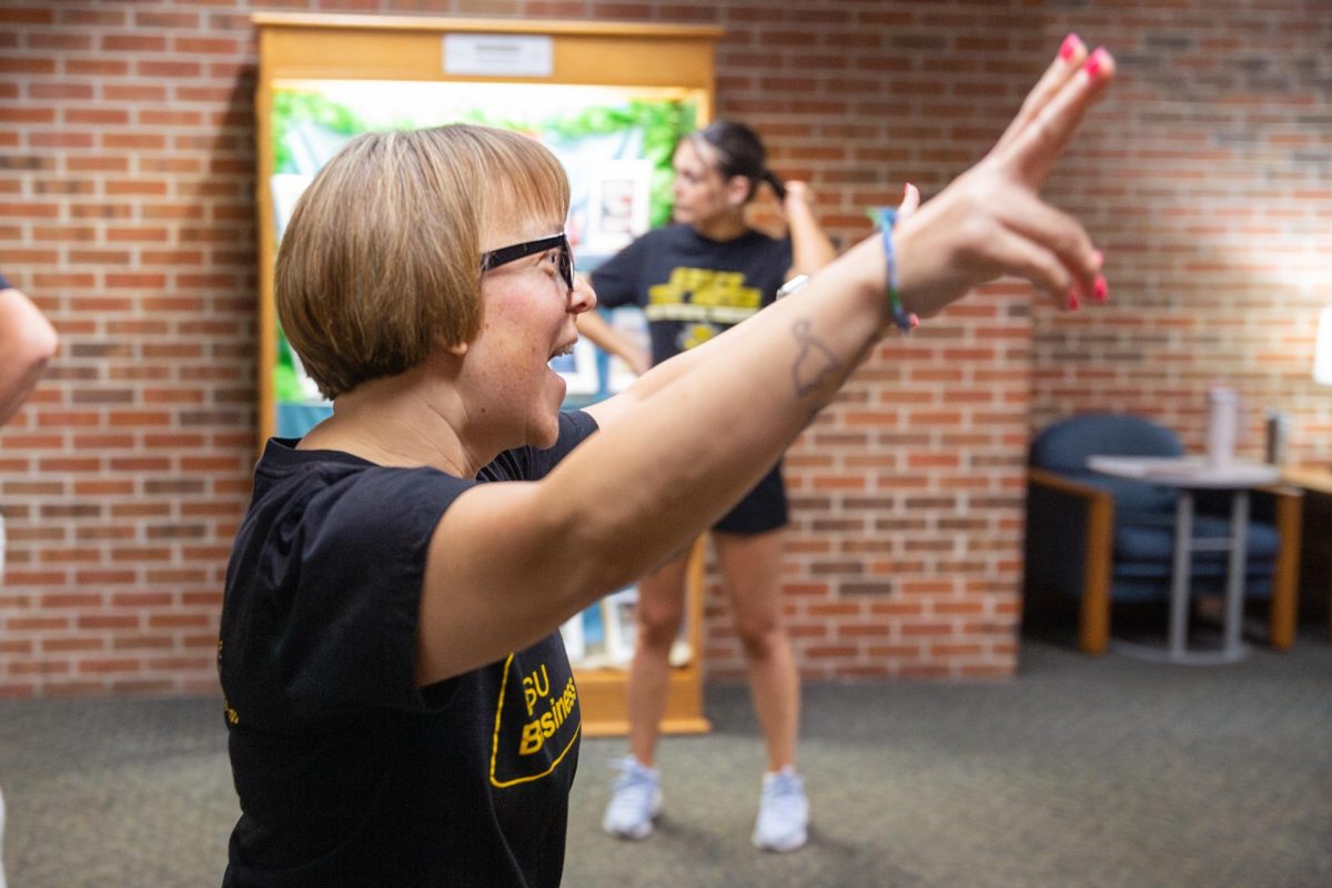 Lisa Bolin cheers after hearing that her team placed first in the second round of the poly spot relay race. Bolin was on the "Just Us League" team, which placed in some competitions.