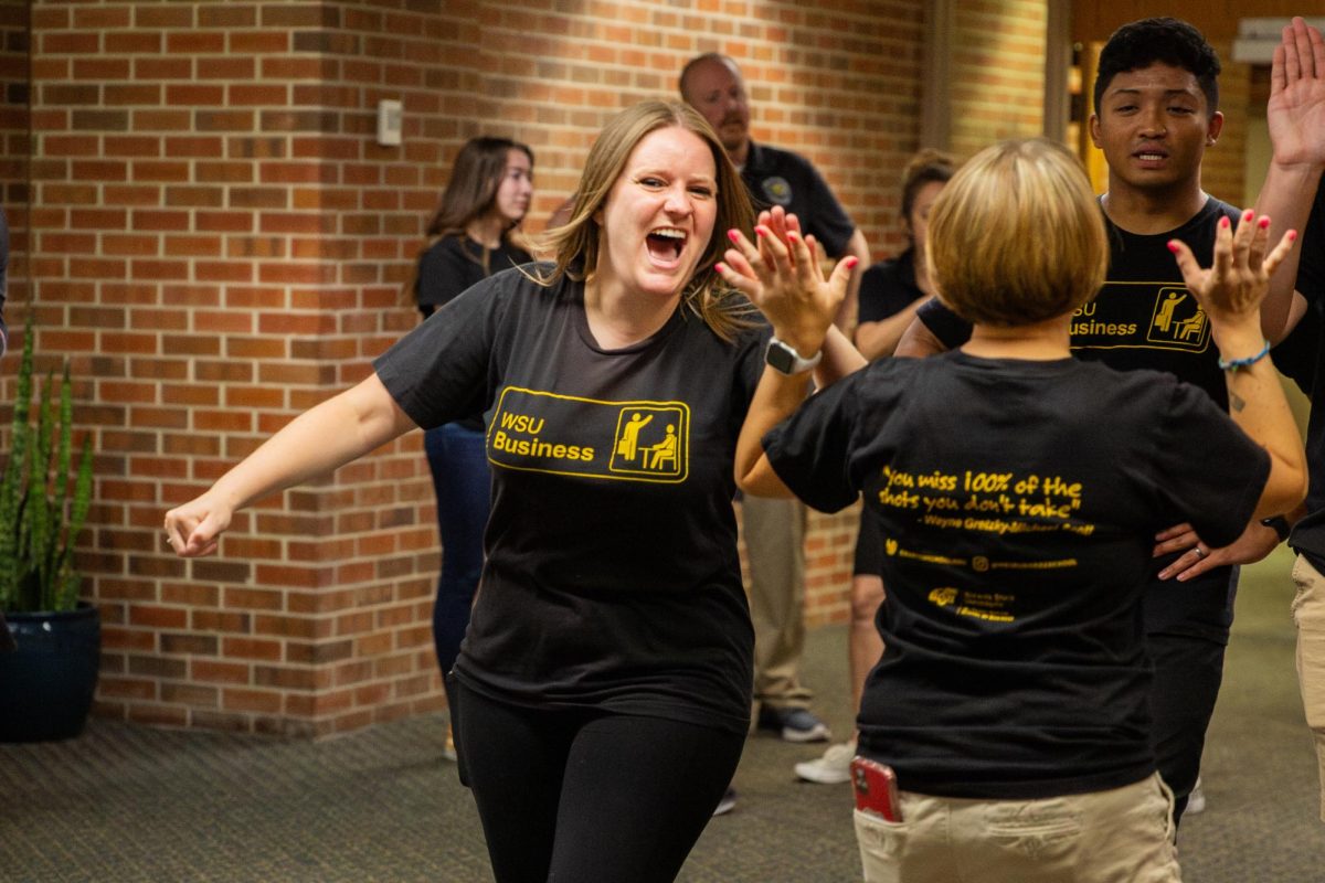 Jaime Scherer high fives Lisa Bolin after hearing that her team won first in the poly spot relay race during the Faculty/Staff Olympics. Scherer and Bolin's team, Just Us League, placed more than once in different competitions.