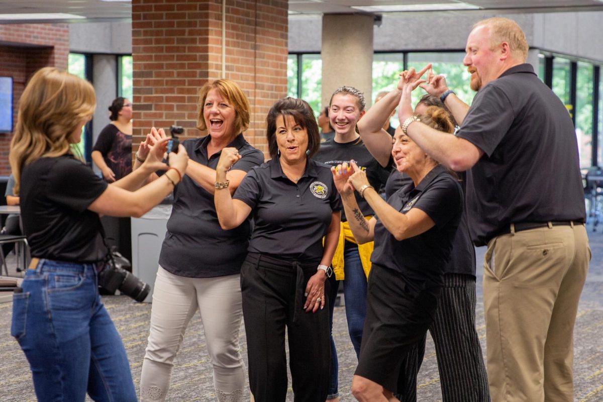 A team made up of faculty and staff from the provost's office pose for a photo following the javelin throwing and poly spot relay race competitions.