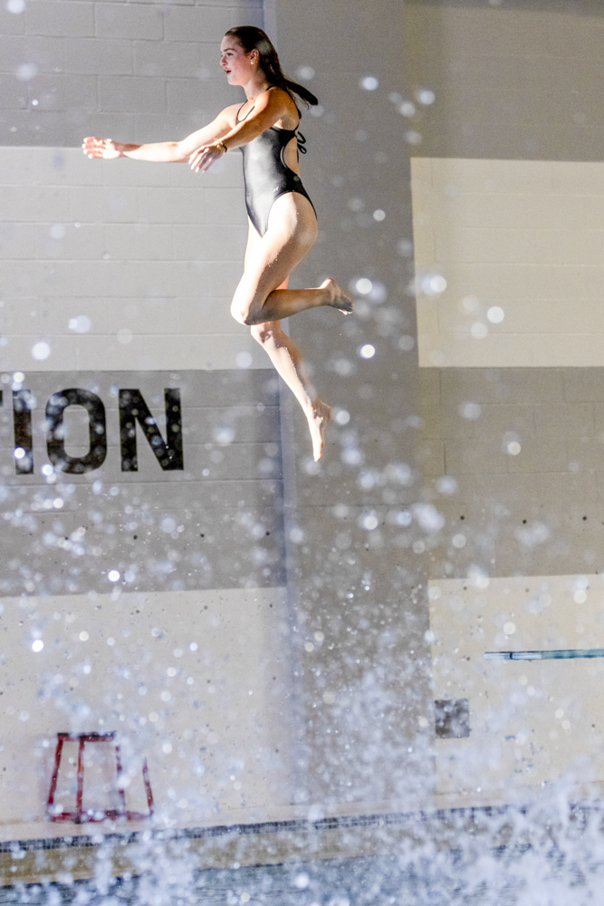 Freshman student-athlete Kylie Scott jumps off the diving board during the annual pool party on Aug. 15 at the Heskett Center.