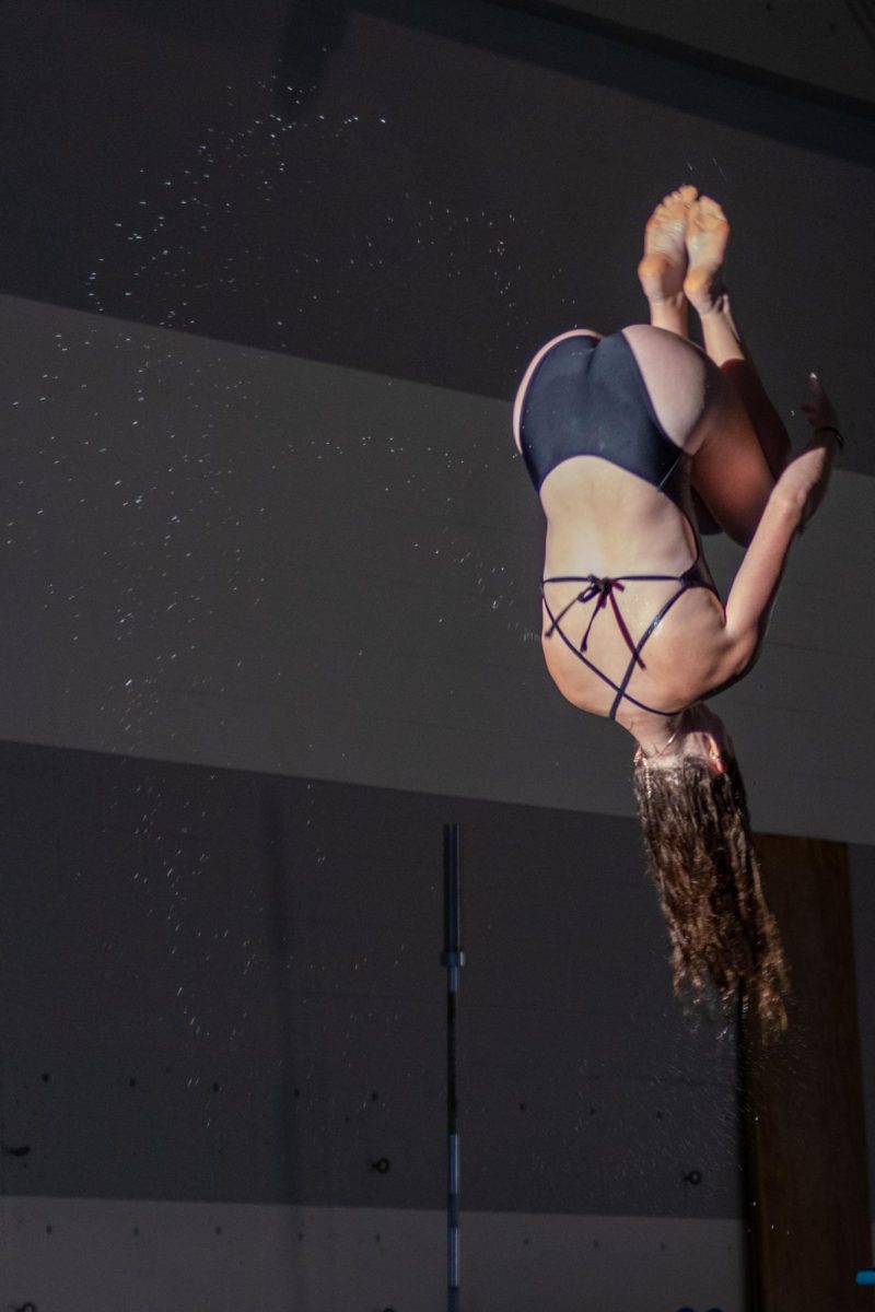 Freshman student-athlete Kylie Scott does a flip at the Heskett Center pool party on Aug. 15. Scott will compete in pole vault for Wichita State track and field in the upcoming year.