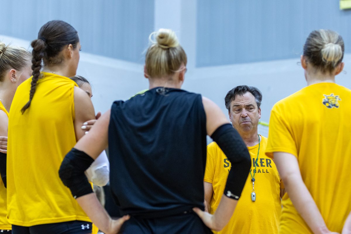 Head coach Chris Lamb closes out practice on Aug. 15 by talking to the Wichita State volleyball team.