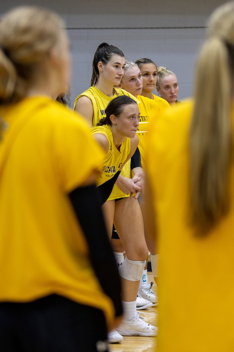 The Wichita State women's volleyball team listens to an end-of-practice talk from assistant coach and recruiting coordinator Katie Zimmerman on Aug. 15.