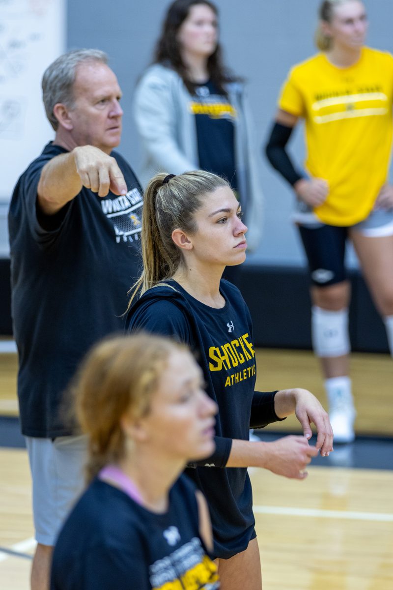 Assistant coach Brian Hosfeld points at Wichita State volleyball defensive specialists/liberos senior Annalie Heliste and sophomore Reagan Anderson during a practice on Aug. 15.