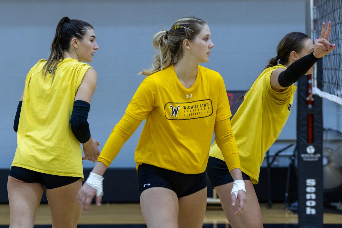 Wichita State volleyball players Emerson Wilford, Izzi Strand and Morgan Stout prepare for a play during a team scrimmage at the end of practice on Aug. 15 in Charles Koch Arena.