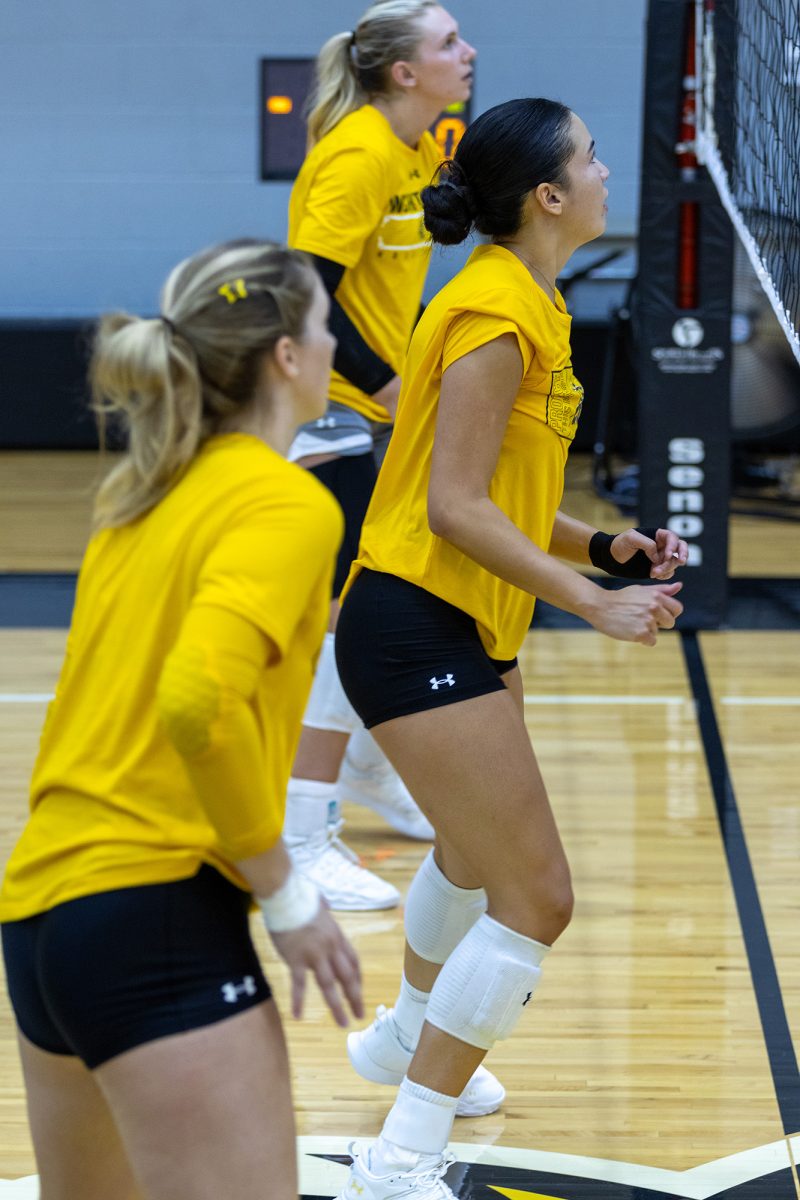 Outside hitter Brooklyn Leggett, middle blocker Sarah Barham and setter Izzi Strand prepare for the ball to come back over during a practice scrimmage on Aug. 15.