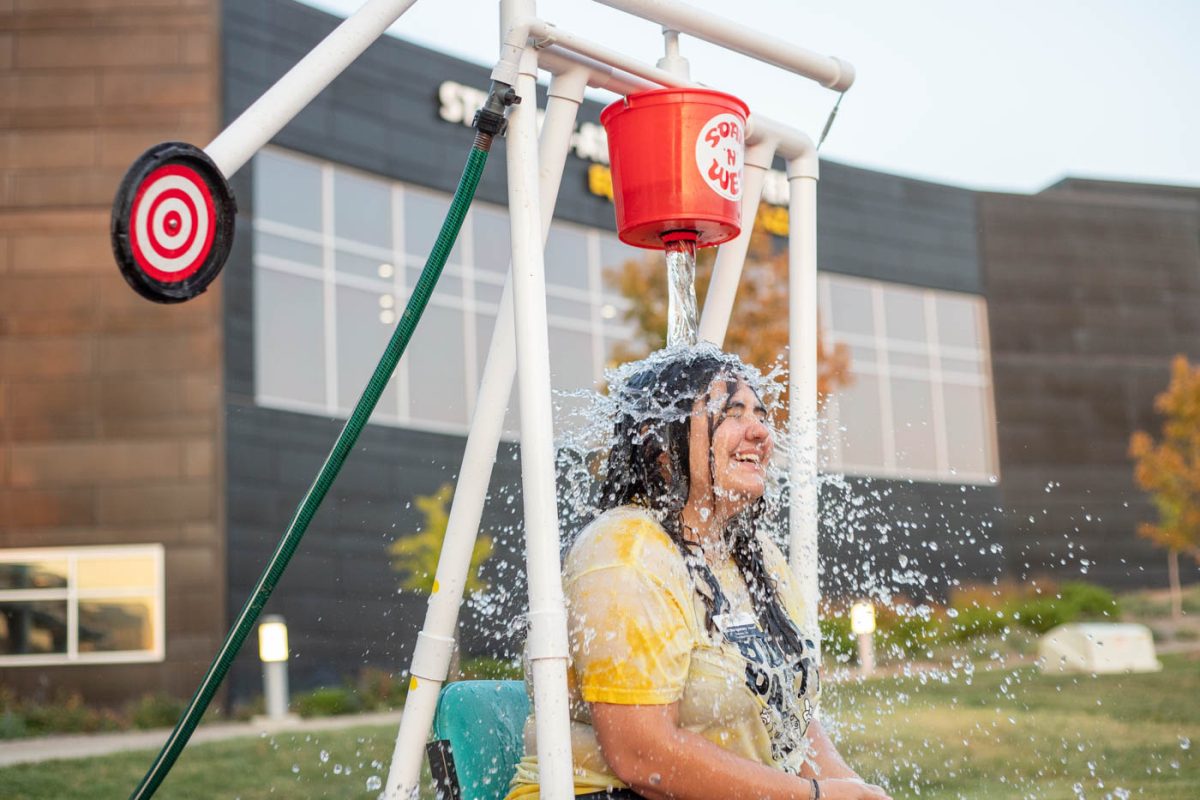 Madi Montgomery, a junior, gets dunked at the water dunking station. Montgomery is a transition mentor who helped set up WSU's first Shocker State Fair.  