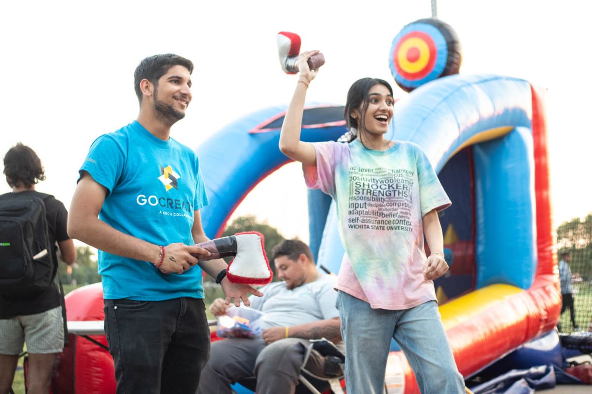 Haiya Patel and Dhruv Lakhiyar, two aerospace engineering students, throw fake axes at the inflatable targets at the Shocker State Fair on Sept. 13. The event, hosted by the Office of First-Year Programs, was held outside of Charles Koch Arena. 