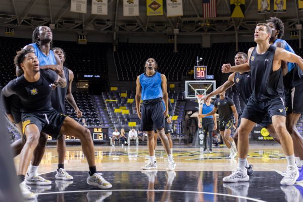 The men's basketball team plays a scrimmage match during practice on Sept. 17. The team played in three teams: red, blue and black.