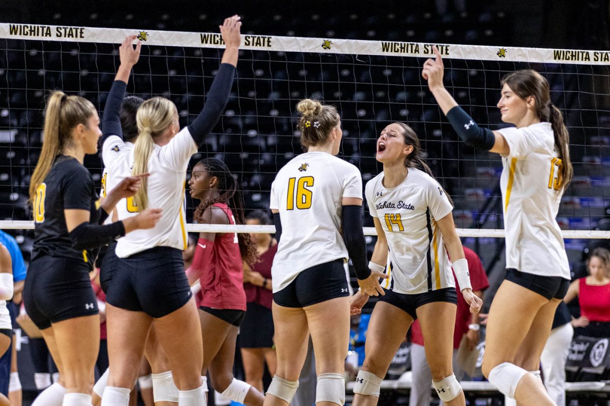 The Shockers celebrate after scoring a point in the second set. Sophomore middle blocker Maddie Wilson, pictured yelling, said her energy after big points helps bring energy to the team. Wichita State beat Temple 3-1 on Sept. 27.