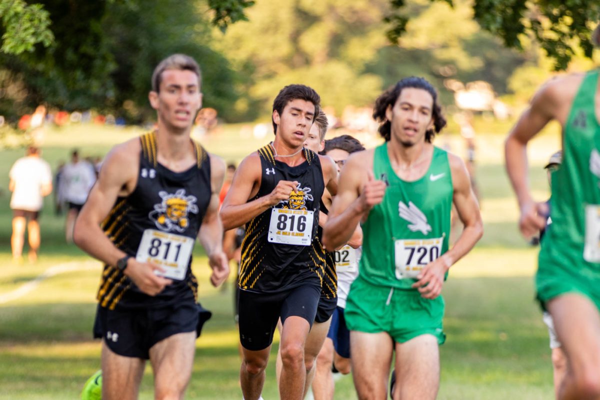 Junior Cesar Ramirez runs towards the finish line during the JK Gold Classic at Clapp Park. Ramirez finished 11 in the race, and scored nine points towards the Wichita State total.