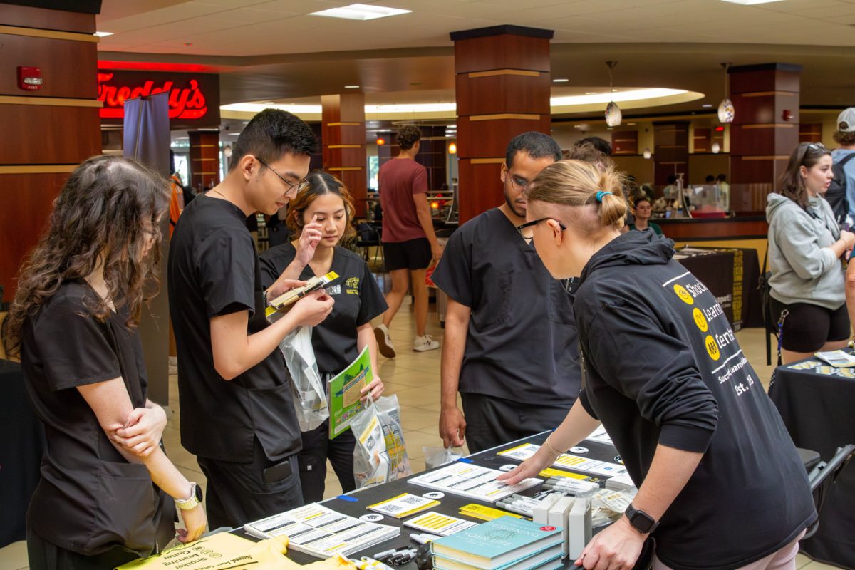 shocker learning center staff members speak with nursing students. they are interested in finding out more about the program.