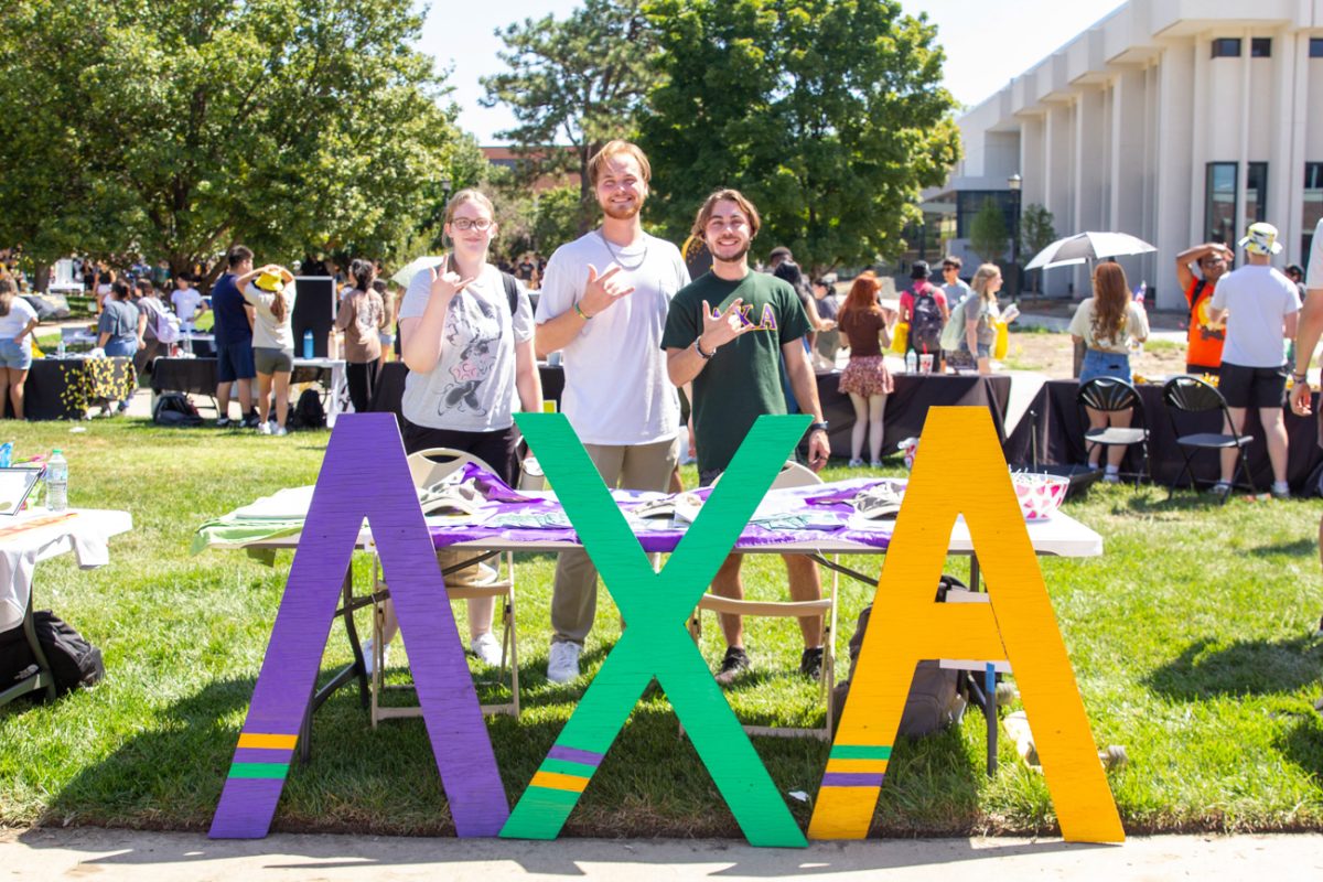 student mason salmond and his friend ryan gibson display the lambda chi alpha salute. they pride themselves in having a good group of friends they call family.