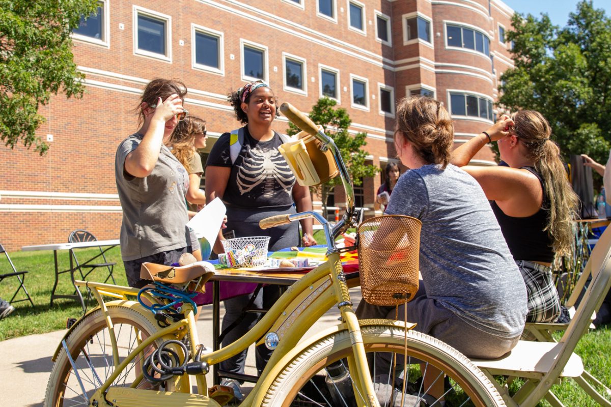 Students at the oSTEM booth converse about the organization they represent. oSTEM, Out in Science, Technology, Engineering, and Mathematics, is one of four LGBTQ+ student organizations on campus.