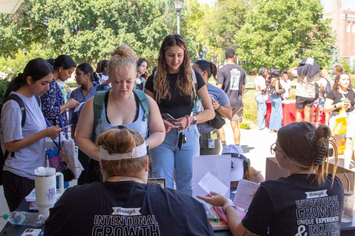 student council activities coordinator jillian belden helps sign students in for the event. the students seemed excited to explore the different opportunities available to them.