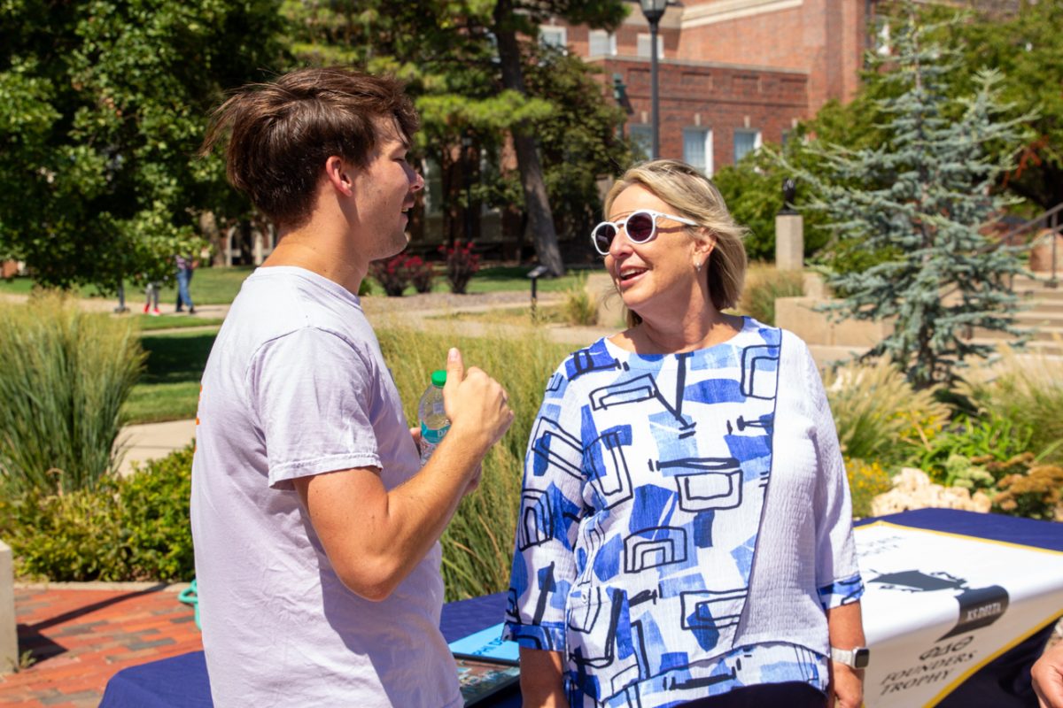 Andrew Lathem and Vice President for Student Affairs Teri Hall speak about Lathem's fraternity. 