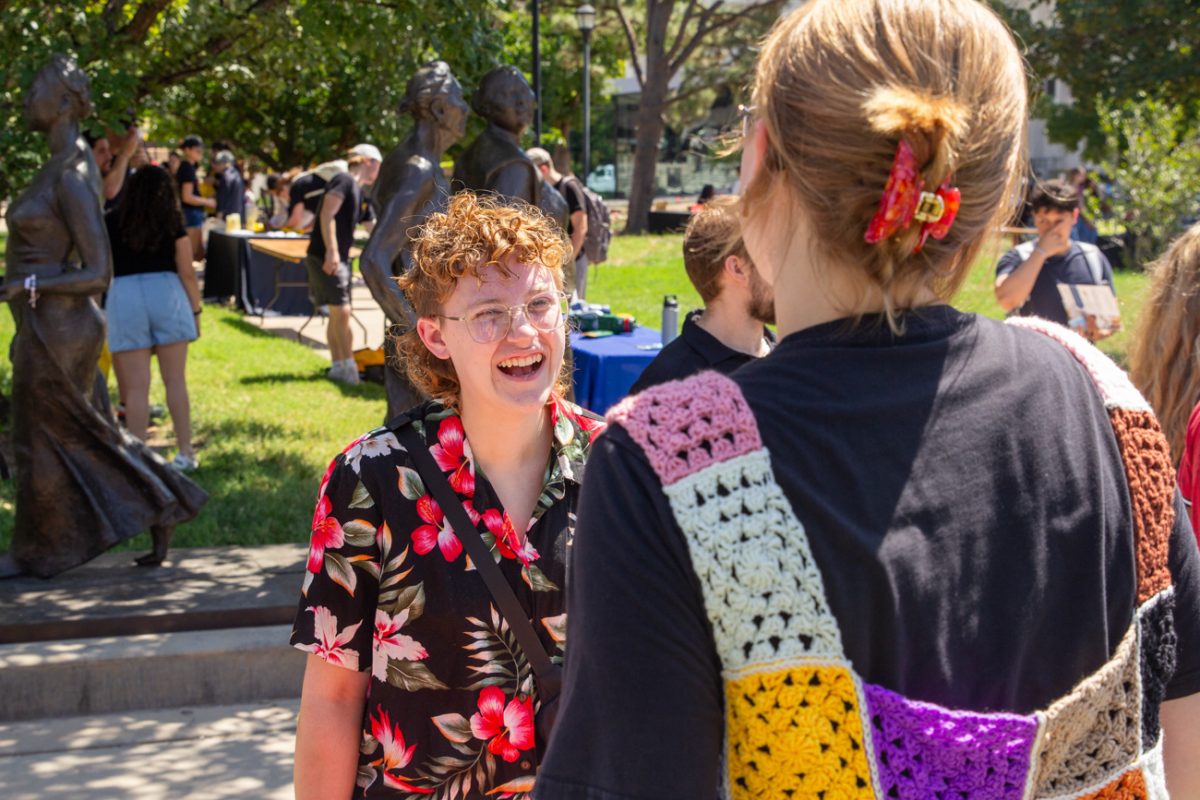 Student Elaine Swan talks to a Spectrum: LGBTQ & Allies program representative about their mission. The representative told Swan about all of the success the program has had.