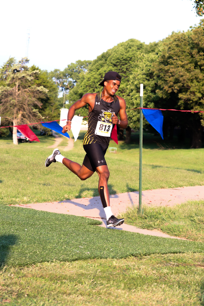 In the lead for WSU on Sept. 7, junior Yared Kidane runs with no other runners in proximity. He placed third in the 6K, this being Kidane's first official race after competing unattached last season.