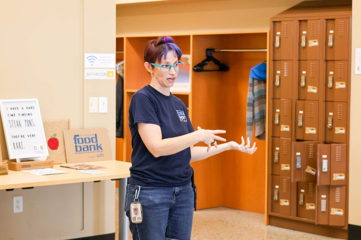 Jillian Ohmarts, a Kansas Food Bank volunteer coordinator, talks to the volunteers about the program before they go inisde. Ohmarts asked the volunteers to be as efficient as possible since many that signed up didn't show.