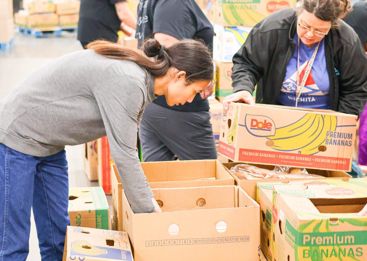 Xia Min Shao, a student member of the community service board, helps sort out bananas into their respective bins. Min was one of three Community Service Board members that signed up to help for Food Bank Friday.