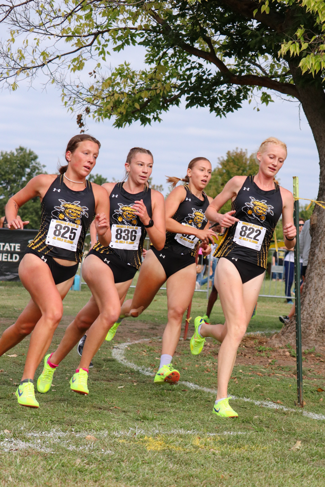 As they round the corner to end their second lap, sophomore Isabelle Hartnett, freshman Emily See, junior Lea Jerkovic and freshman Faith Ekart form a line that stretches the width of the course. The women paced in a group for most of the race on Sept. 7, and all finished within 30 seconds of each other.