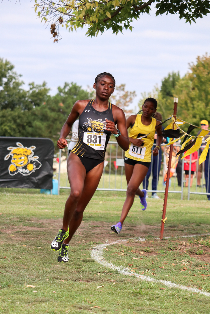 Rounding the corner, senior Farrah Miller keeps her pace as runners follow her tail during the JK Gold Classic. Miller was the ninth runner to cross the finish line for Wichita State at its new home course at L.W. Clapp Park.