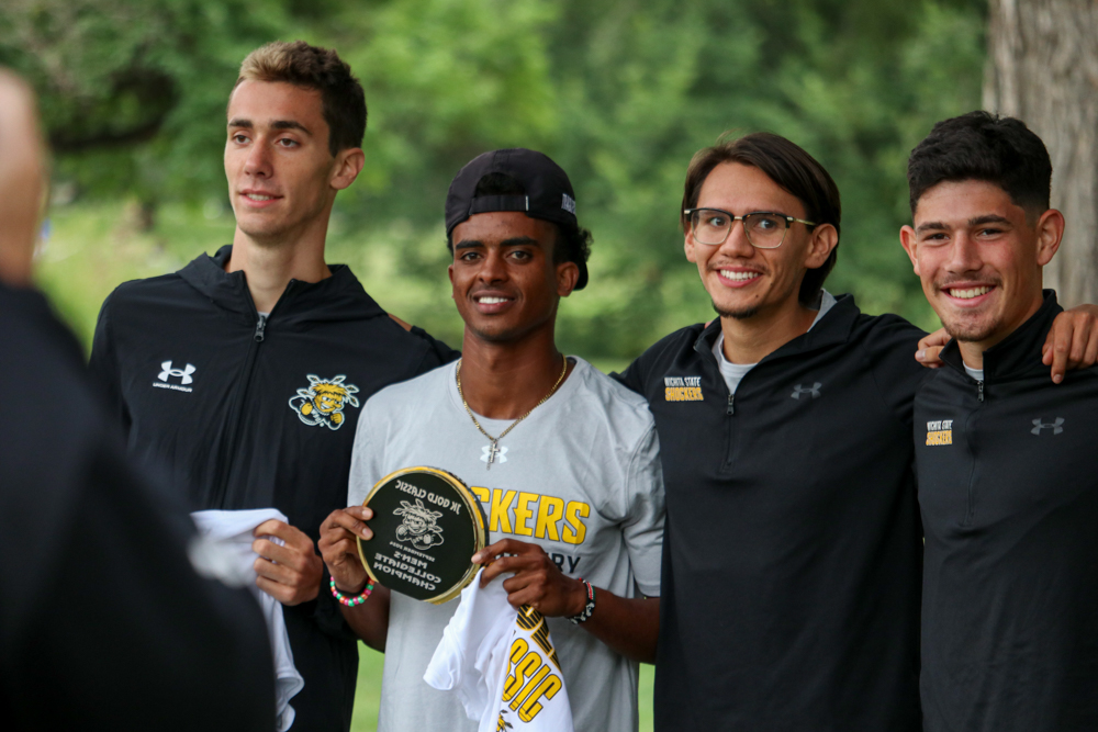 Redshirt freshman Colin Graham, junior Yared Kidane, senior Erik Enriquez and sophomore Aidan Reyna pose for photos with their award after winning the JK Gold Classic on Sept. 7. The men's team won its third consecutive JK Gold Classic with 46 points.