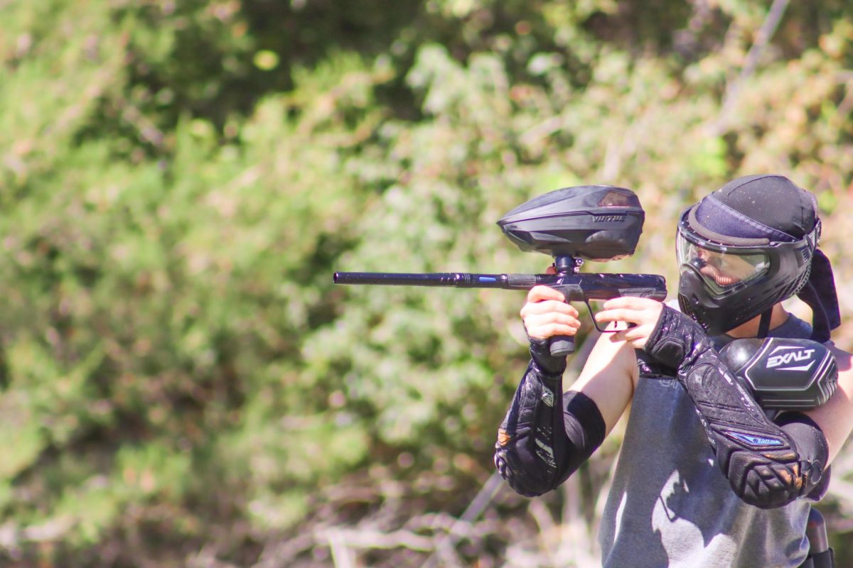 Senior Tanner Radford, the founder of the WSU Paintball Club, lines up to take a shot.