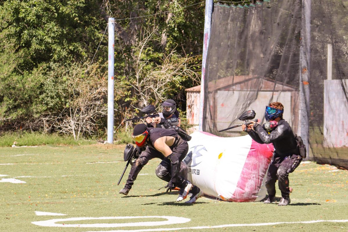 A group of Wichita State Paintball Club members sprint onto the field to start a game. The club began with just four members and has since grown to nearly 100.